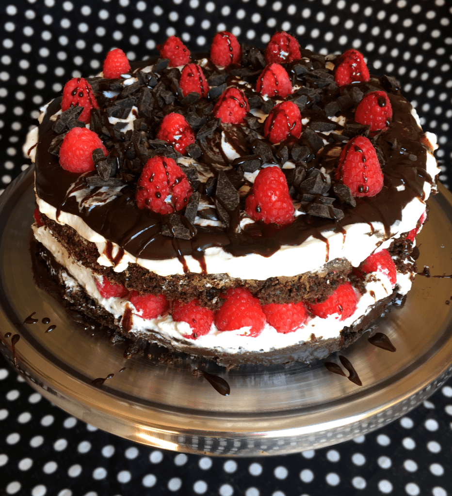 Healthy-ish chocolate cake with raspberries and whipped cream 