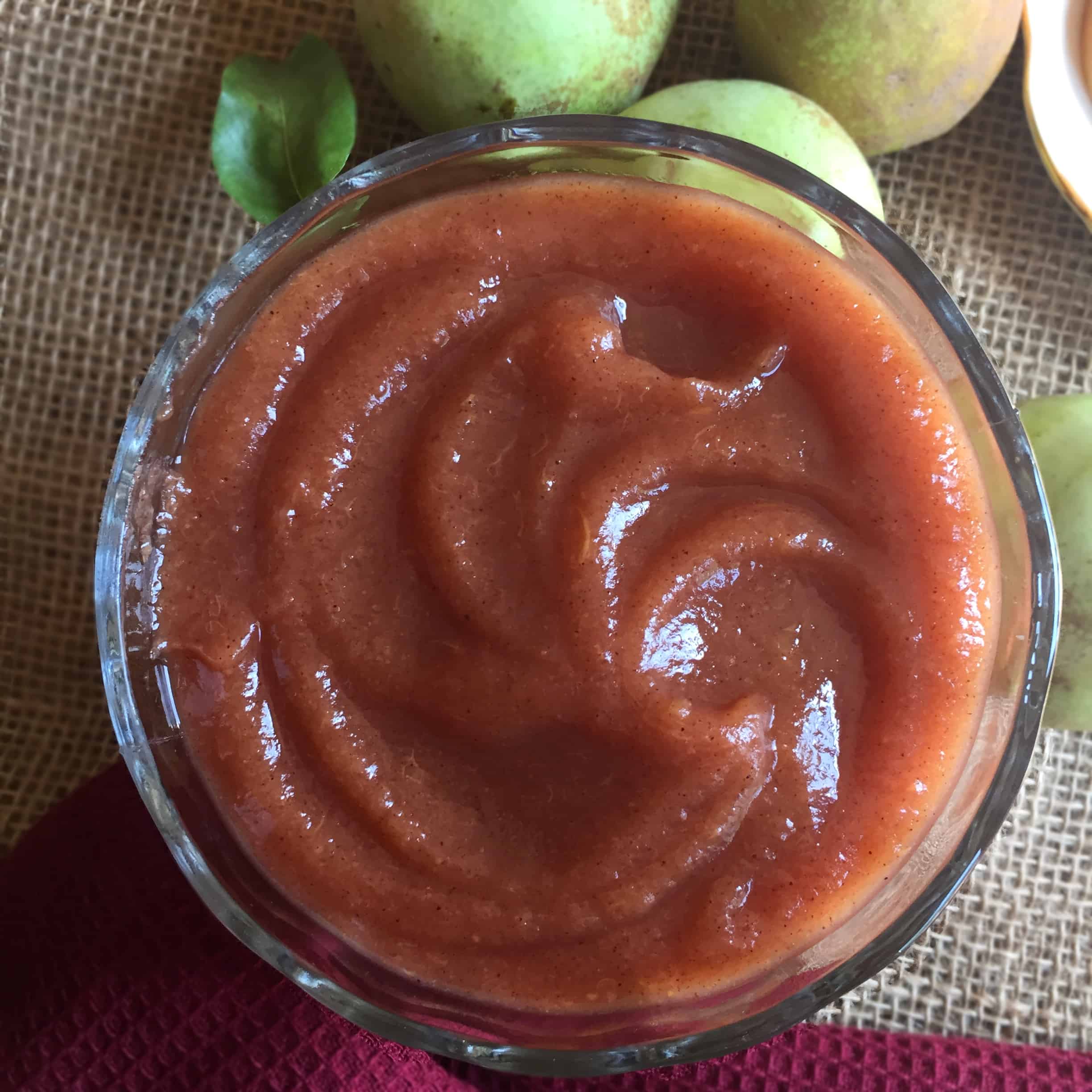 pear butter in a bowl with pears in the background